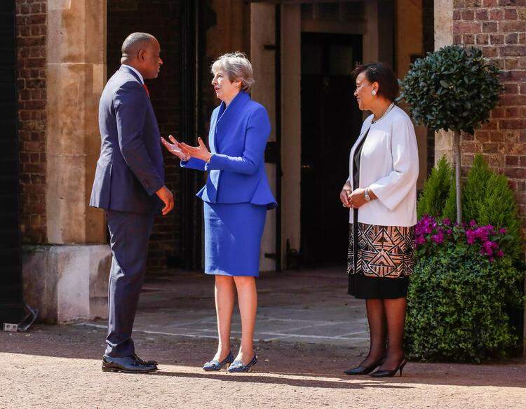 U.K. Prime Minister Teresa May and Commonwealth Secretary General Patricia Scotland welcome Roosevelt Skerrit