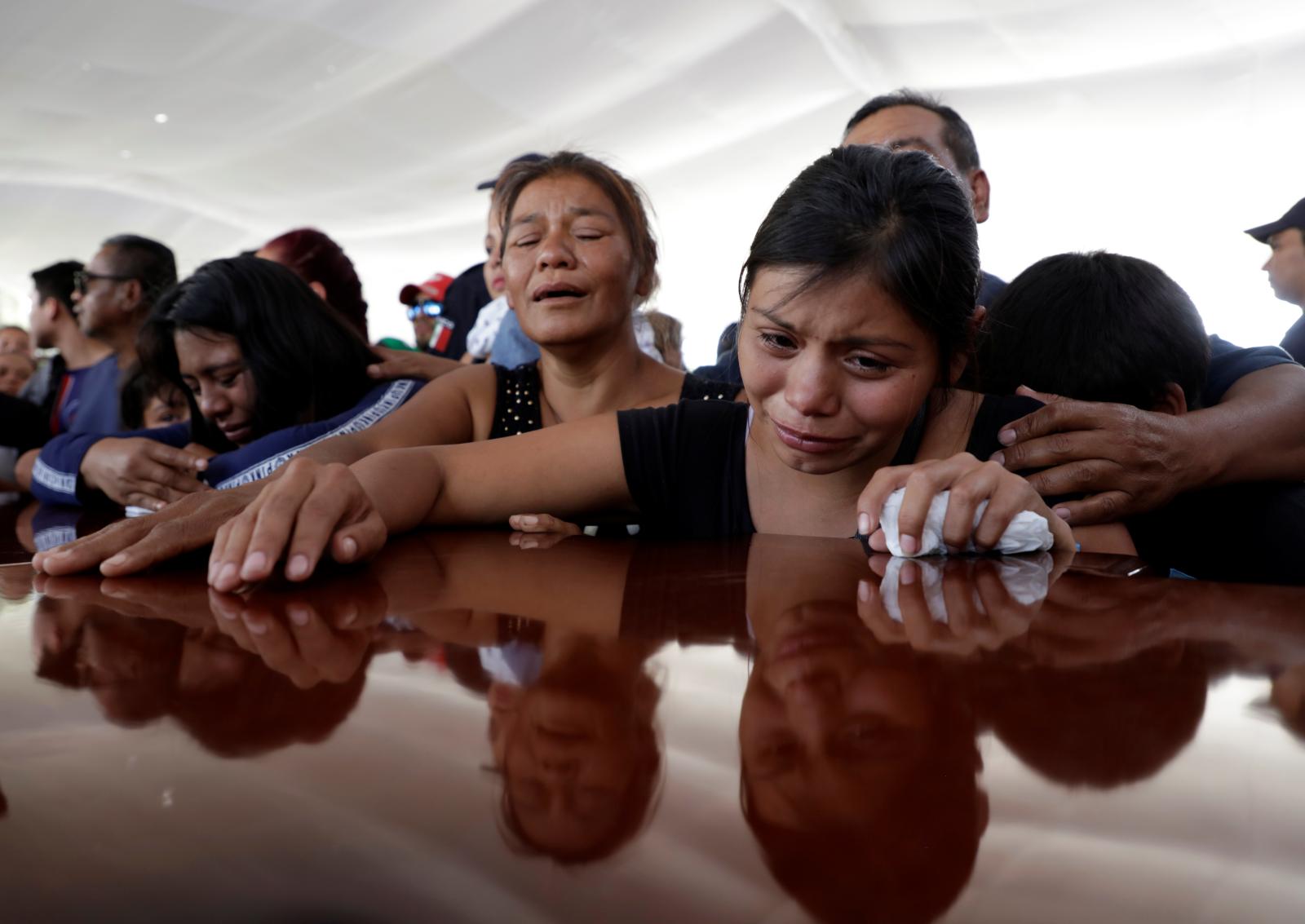 Relatives of a police officer, who was killed along with other fellow police officers during an ambush by suspected cartel hitmen, react during an homage organised by the state government, in Morelia, in Michoacan state, Mexico October 15, 2019. REUTERS/Alan Ortega
