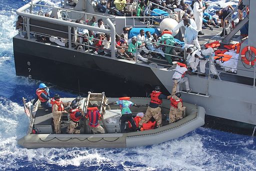 Distressed persons are transferred to a Maltese patrol vessel. 2