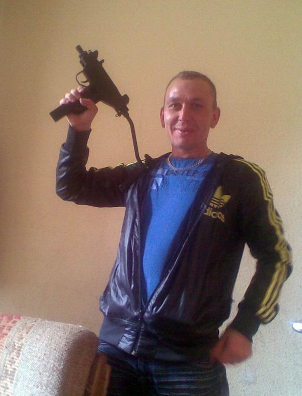 Gintas Vengalis, who was convicted of working for the Russians in 2015, holding a machine gun