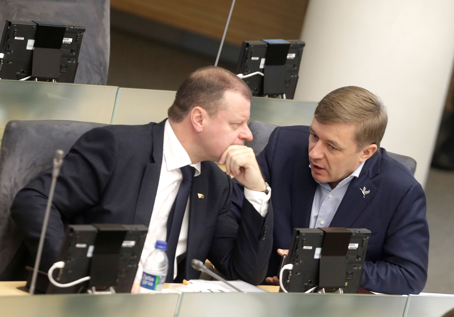 Saulius Skvernelis listens to Ramunas Karbauskis before his swearing in as prime minister in the Seimas, the Lithuanian parliament, December 2016. Credit: Ints Kalnins / Reuters