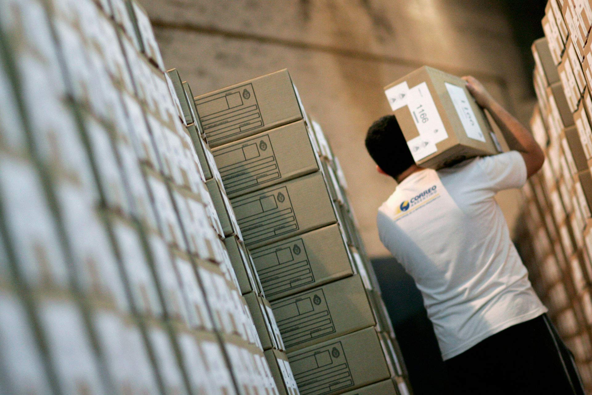 A post office worker carries a ballot box for the presidential election in Buenos Aires on October 21, 2011.